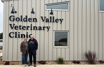 Owners standing in front of the business building